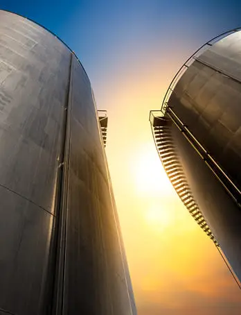 Industrial storage tanks with protective coatings demonstrating construction chemicals applications in infrastructure