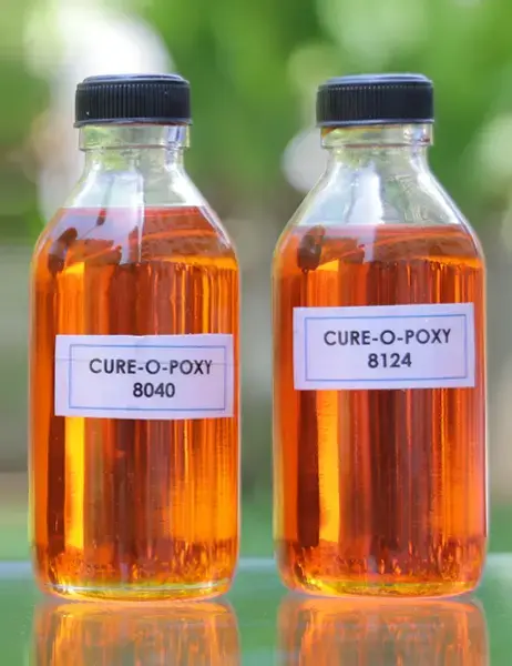 CURE-O-POXY superior epoxy hardeners NSP Series - two bottles of amber-colored curing agents labeled 8040 and 8124